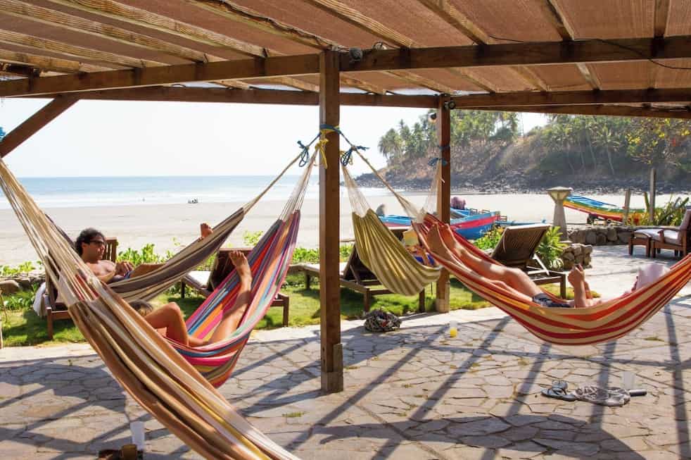 Hammocks on the beach at El Salvador resort, perfect for relaxing during your Pacific vacation.