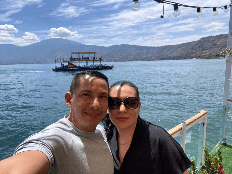 Boat tour on Lake Coatepeque in El Salvador with a couple enjoying the scenic views.
